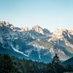 A vertical high angle shot of Valbona Valley National Park under a clear blue sky in Albania